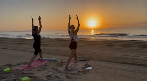 Lola is yoga on Guardamar beach at sunrise